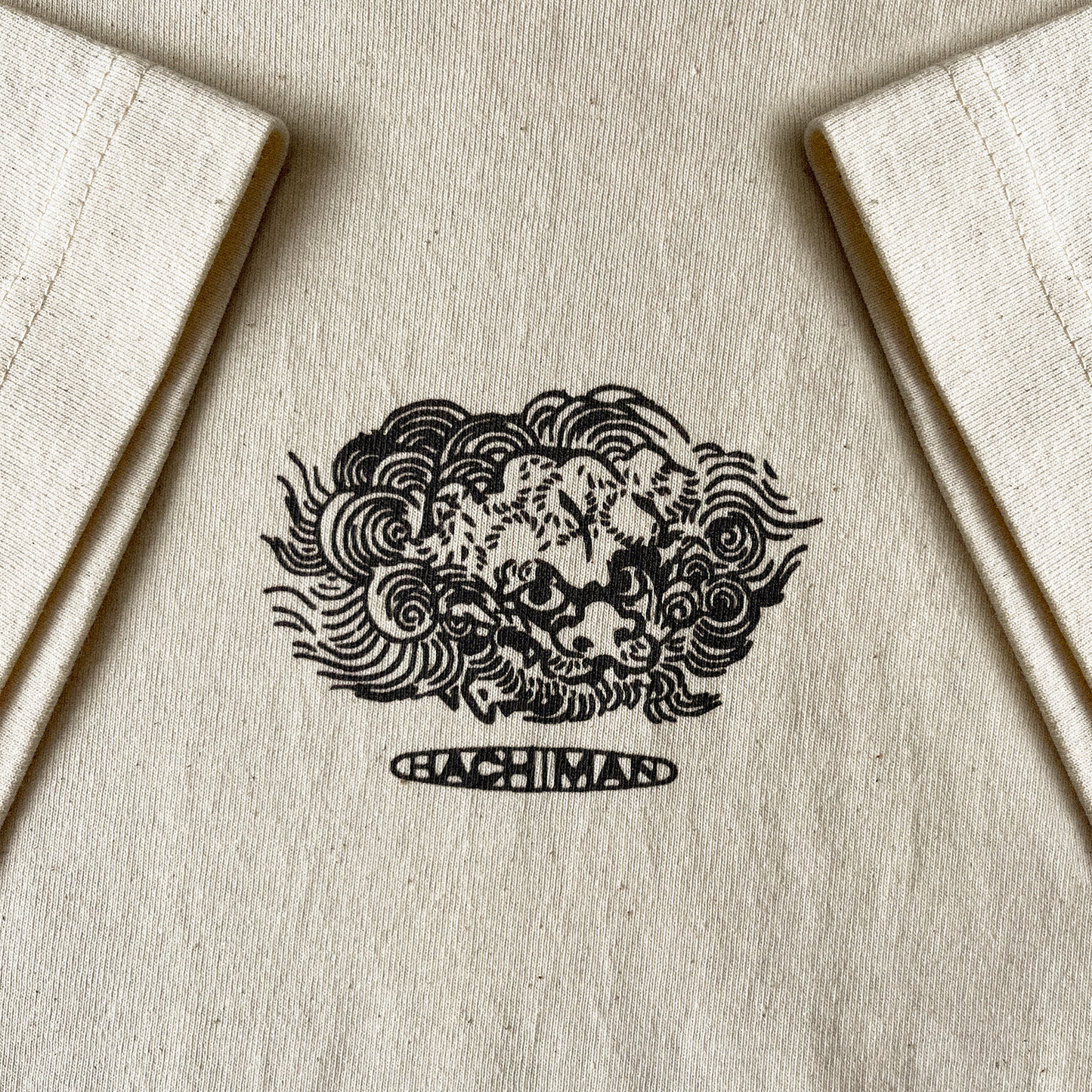 Close up of Hachiman JPN natural ecru oversized organic t-shirt featuring a brown front print of a Japanese lion dog (Komainu) 