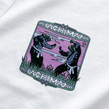 Close up of a Hachiman JPN white oversized organic t-shirt featuring a pink, black and green front print of a martial art standoff between two Japanese frogs wearing judo robes.