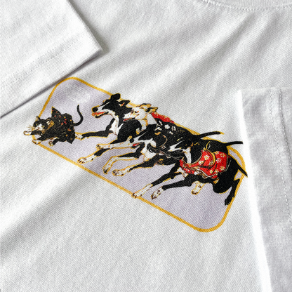 White relaxed organic t-shirt with a Japanese graphic of a cat wearing a kimono scurrying away from several greyhounds. Close up.